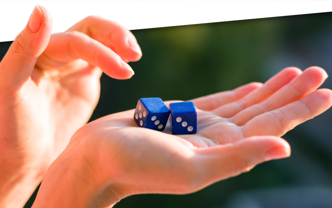 Dice 1 1 in the female hand, sunset background. Forecasting to zero. Game of chance concept.